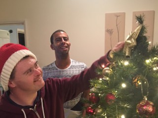 Diagrama Foundation: One of the Cabrini House residents putting the star on the Christmas tree.